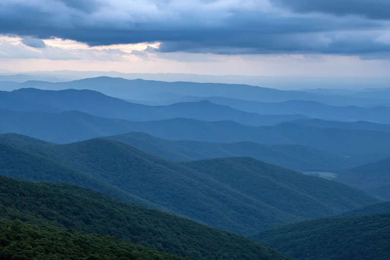 Layered appalachian mountain ridges receding into hazy distance under overcast sky
