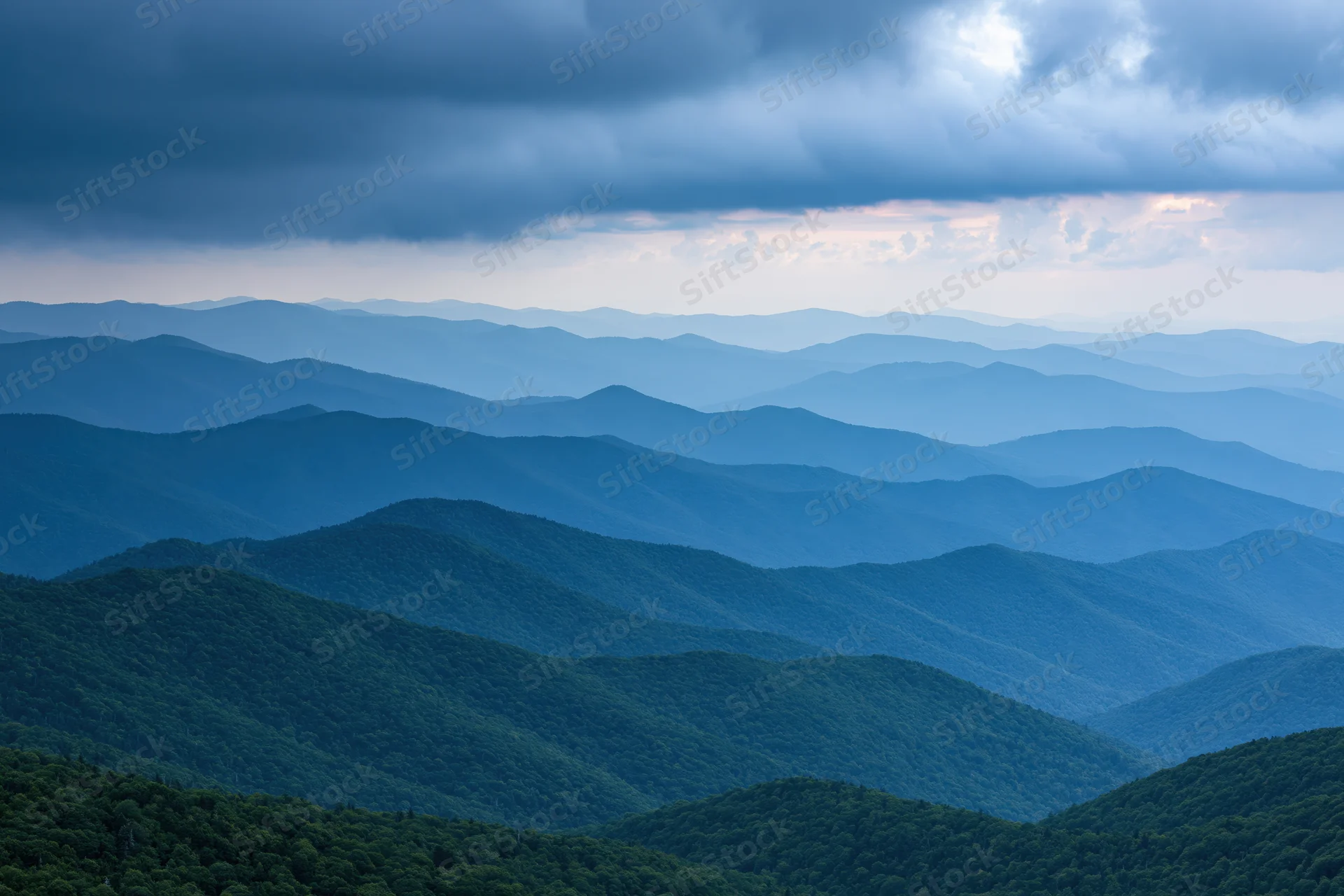 Layered appalachian mountain ridges receding into hazy distance under overcast sky