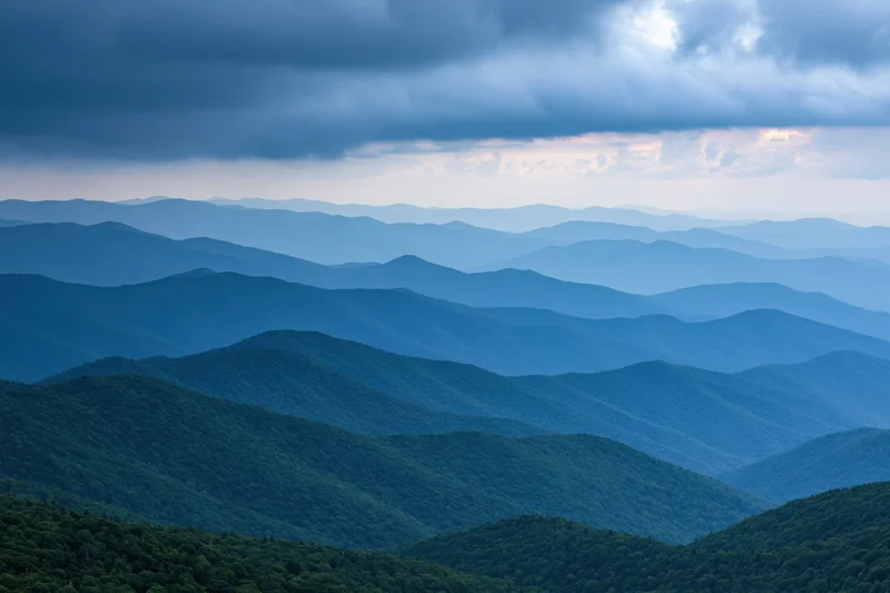 Layered appalachian mountain ridges receding into hazy distance under overcast sky