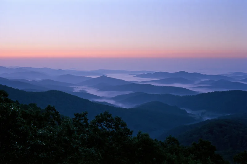 Layered appalachian mountain ridges receding into the distance at dawn with mist in the valleys