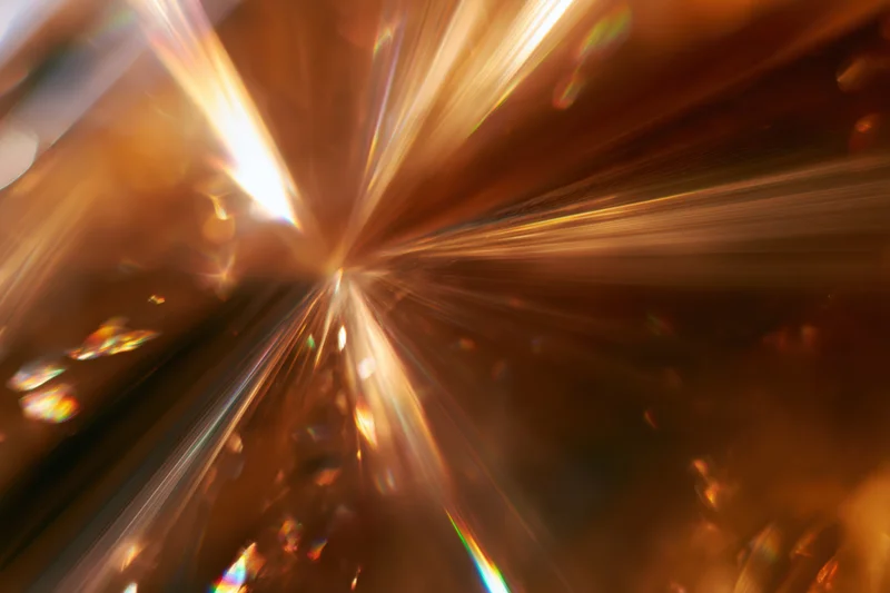 Light refracting through a glass crystal creating a radiant spectrum of colors in motion