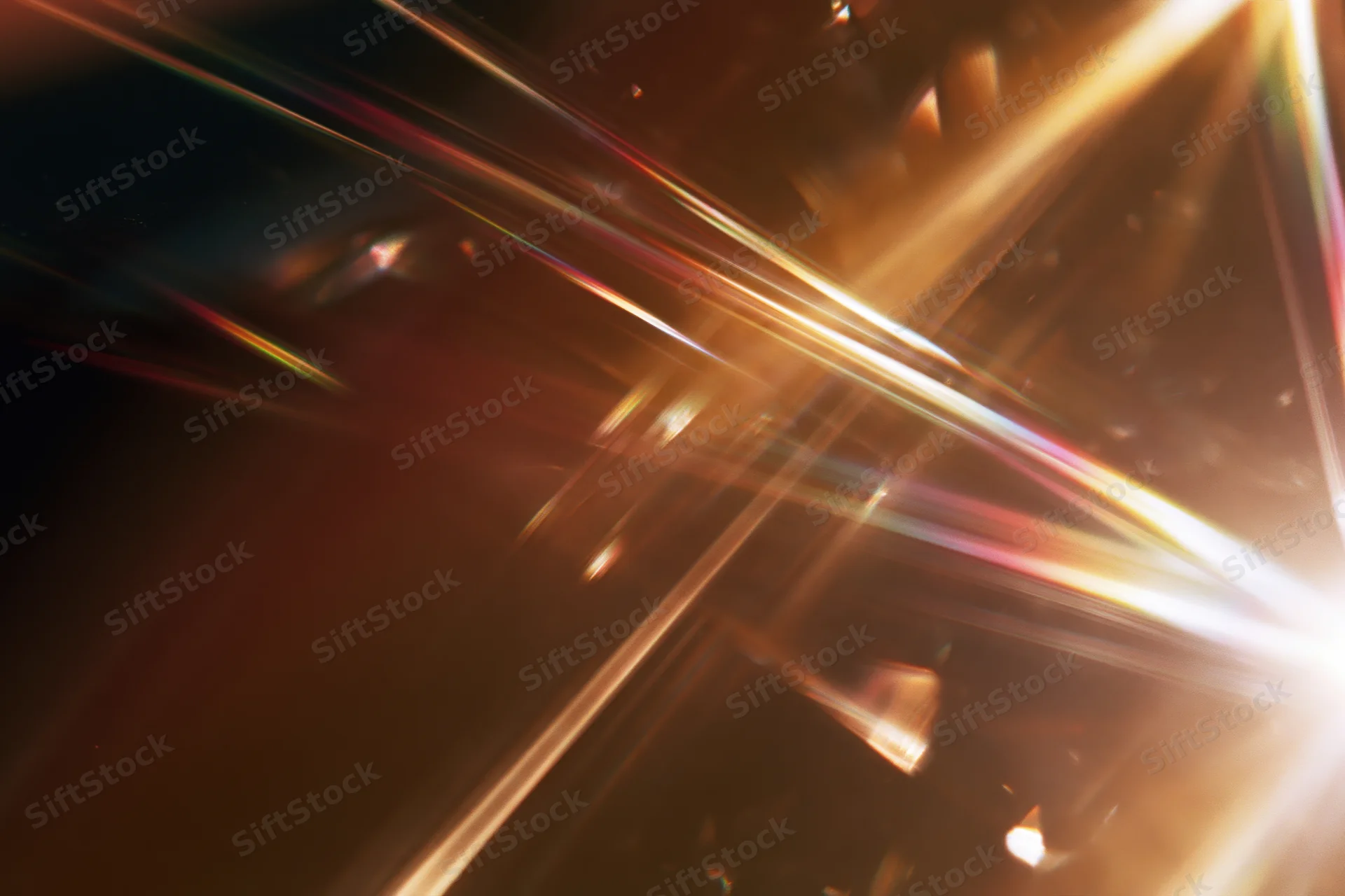 Light refracting through a glass crystal creating colorful beams and flares