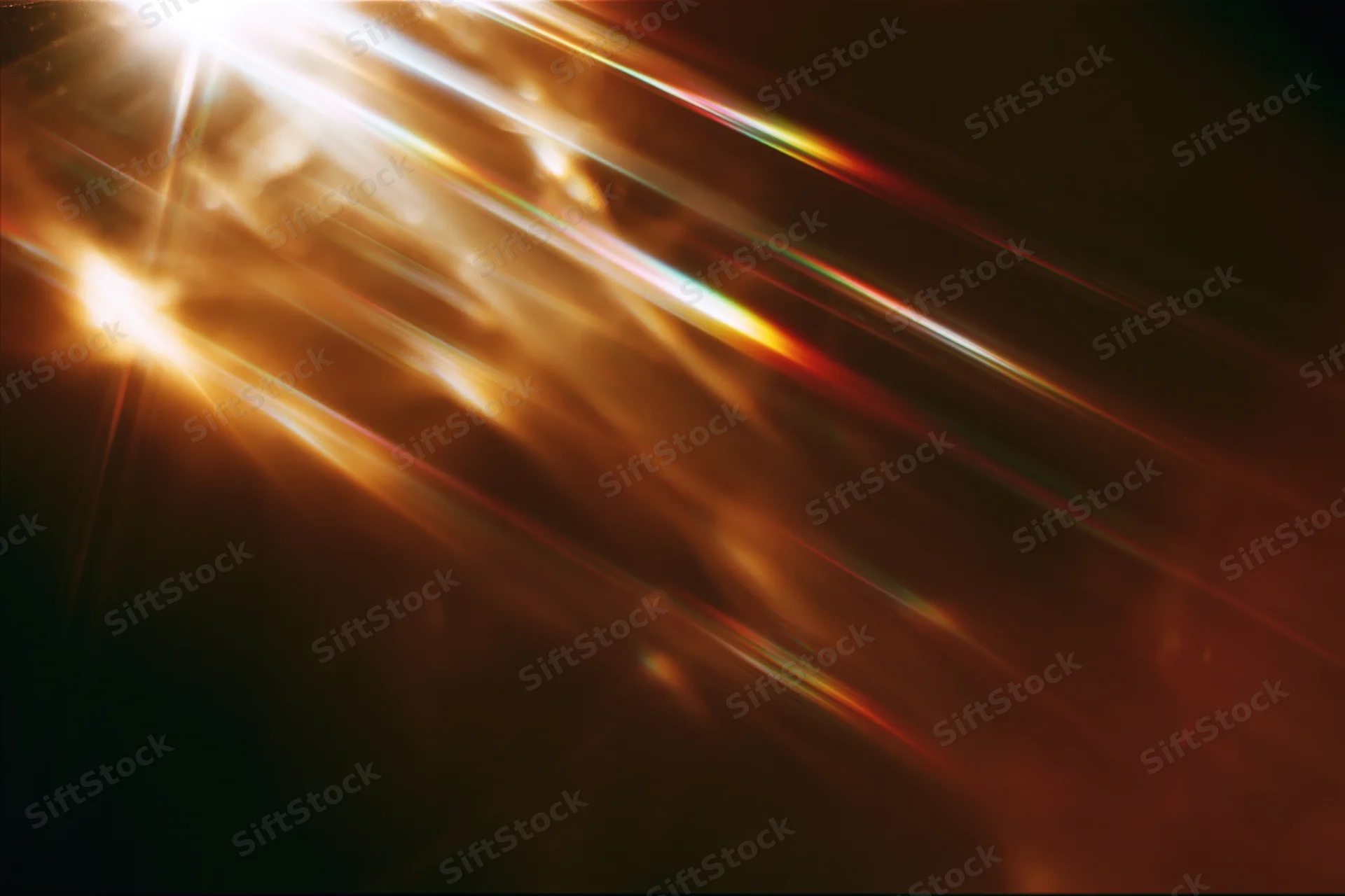 Light refracting through a glass crystal creating colorful beams and flares against a dark background with copyspace