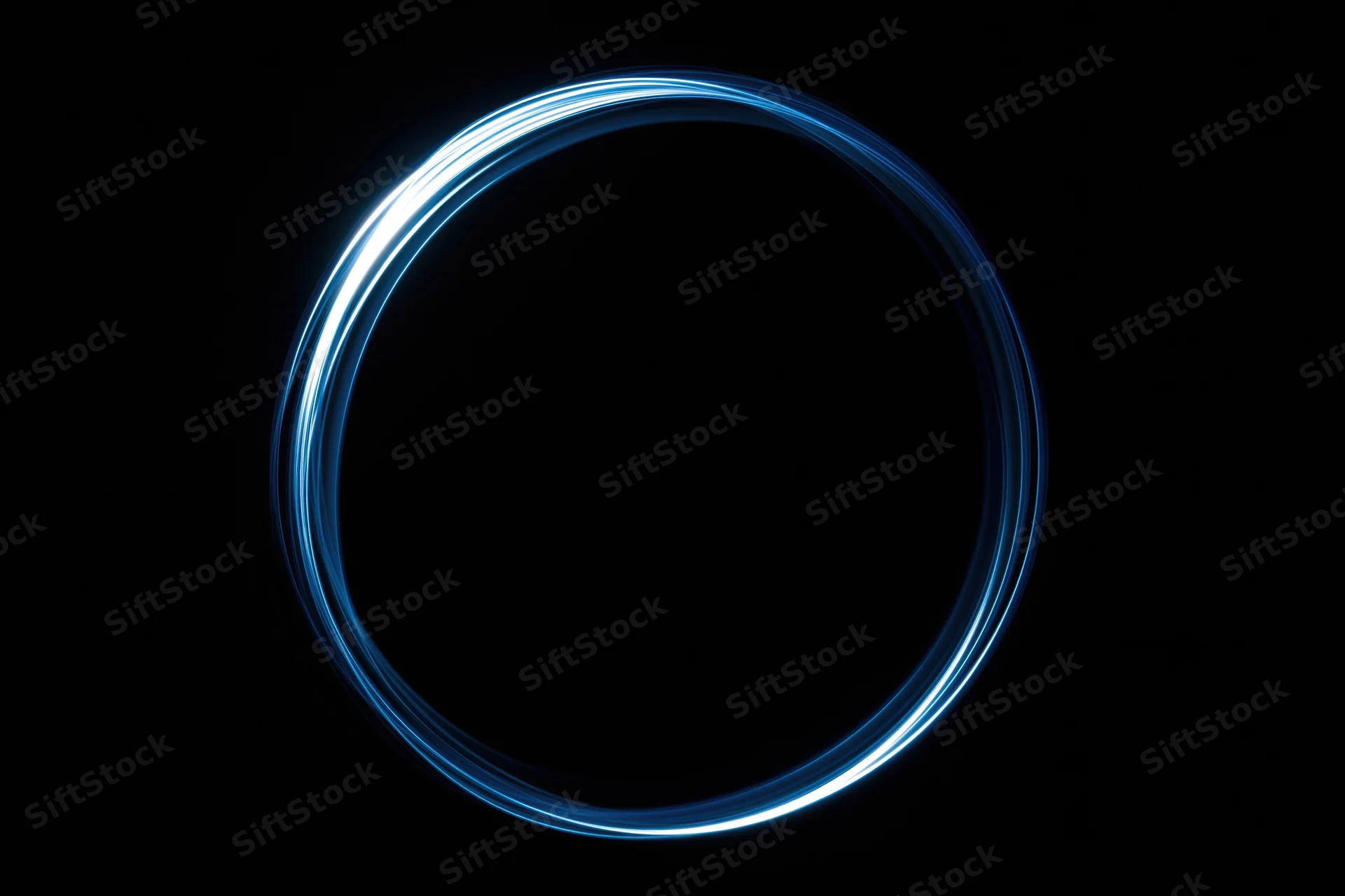 Glowing blue circular light trail against black background from long-exposure light painting photography