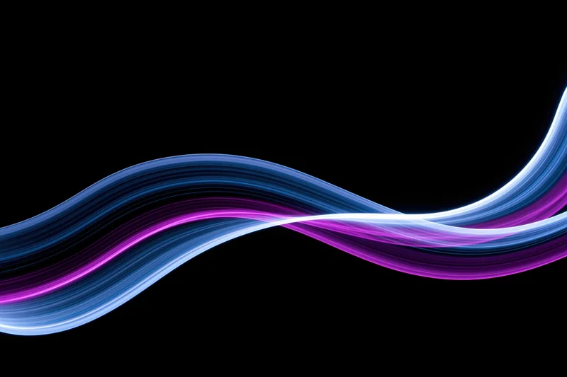 Flowing parallel light waves in blue and purple hues against black background