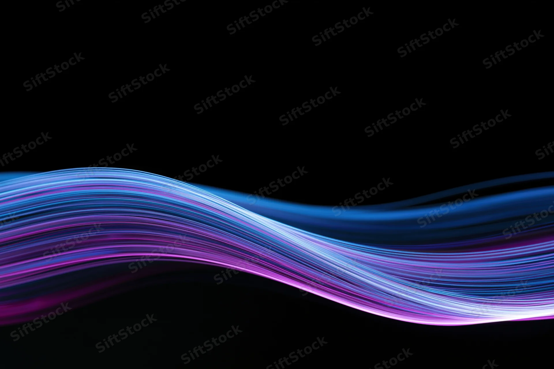 Glowing fiber-optic light wave in motion against black background