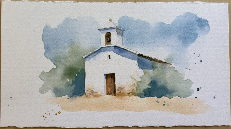 Small white country church with bell tower and tiled roof in rural landscape