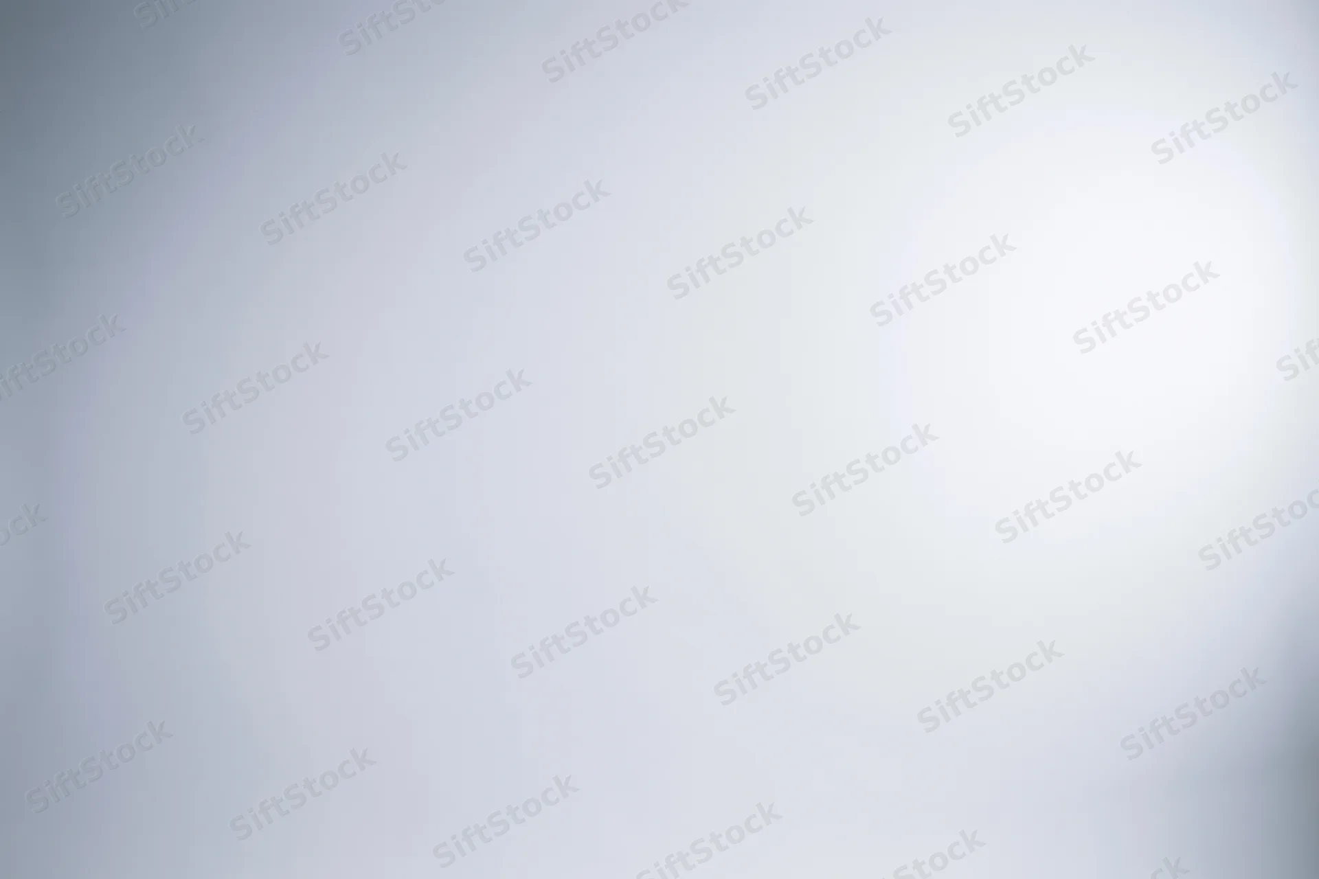 White-to-light-grey gradient background in empty studio space
