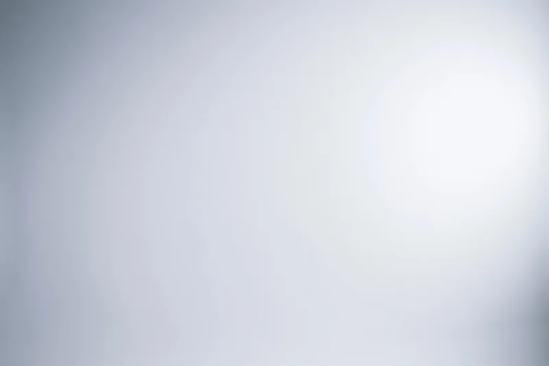 White-to-light-grey gradient background in empty studio space
