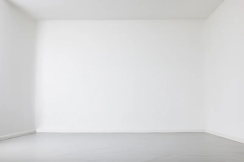 Empty white room with smooth flooring and plain walls, interior space for display or photography