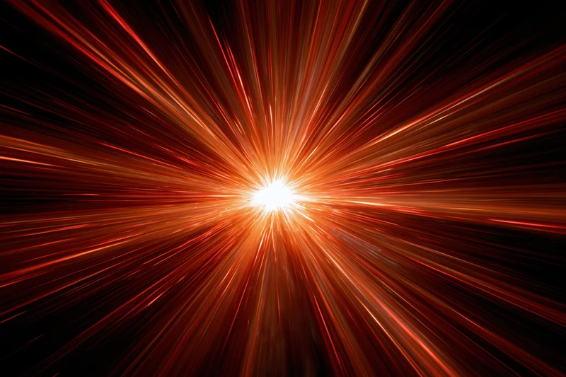 Radial light burst exploding from a central glowing point in dark space