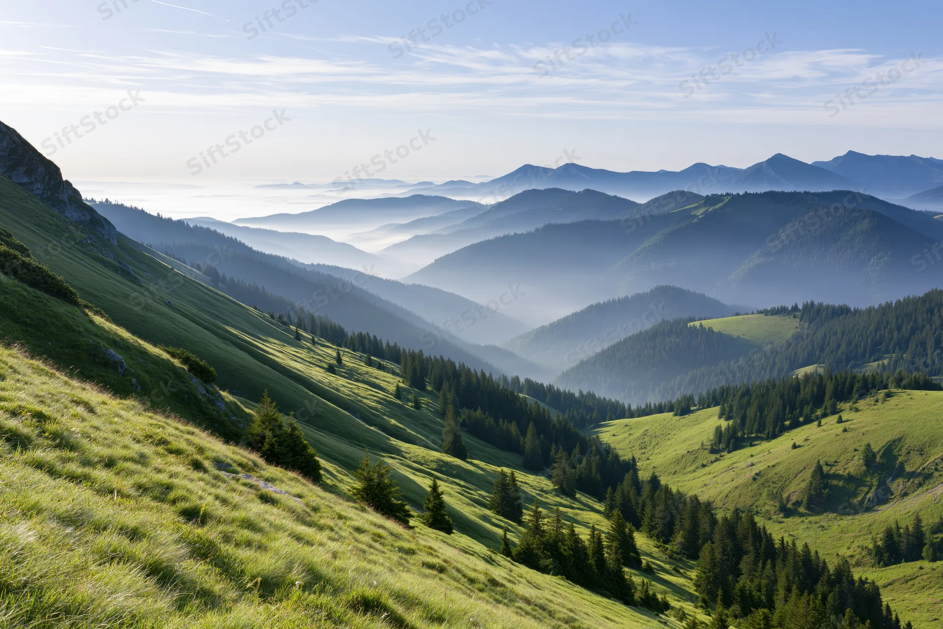Rolling green mountain meadows with scattered conifer forests under a hazy sky