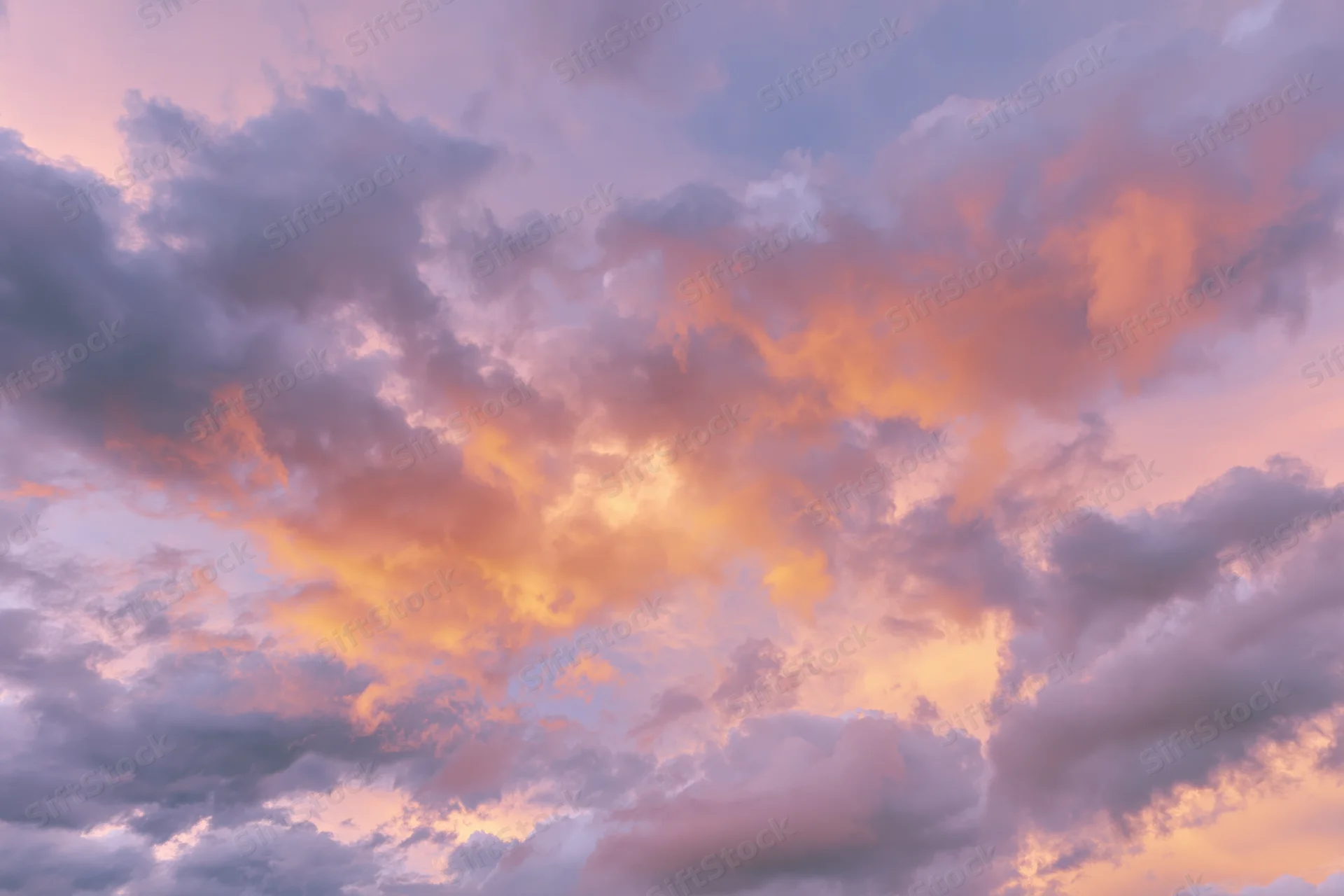 Soft cumulus clouds filling the frame at sunset viewed from below