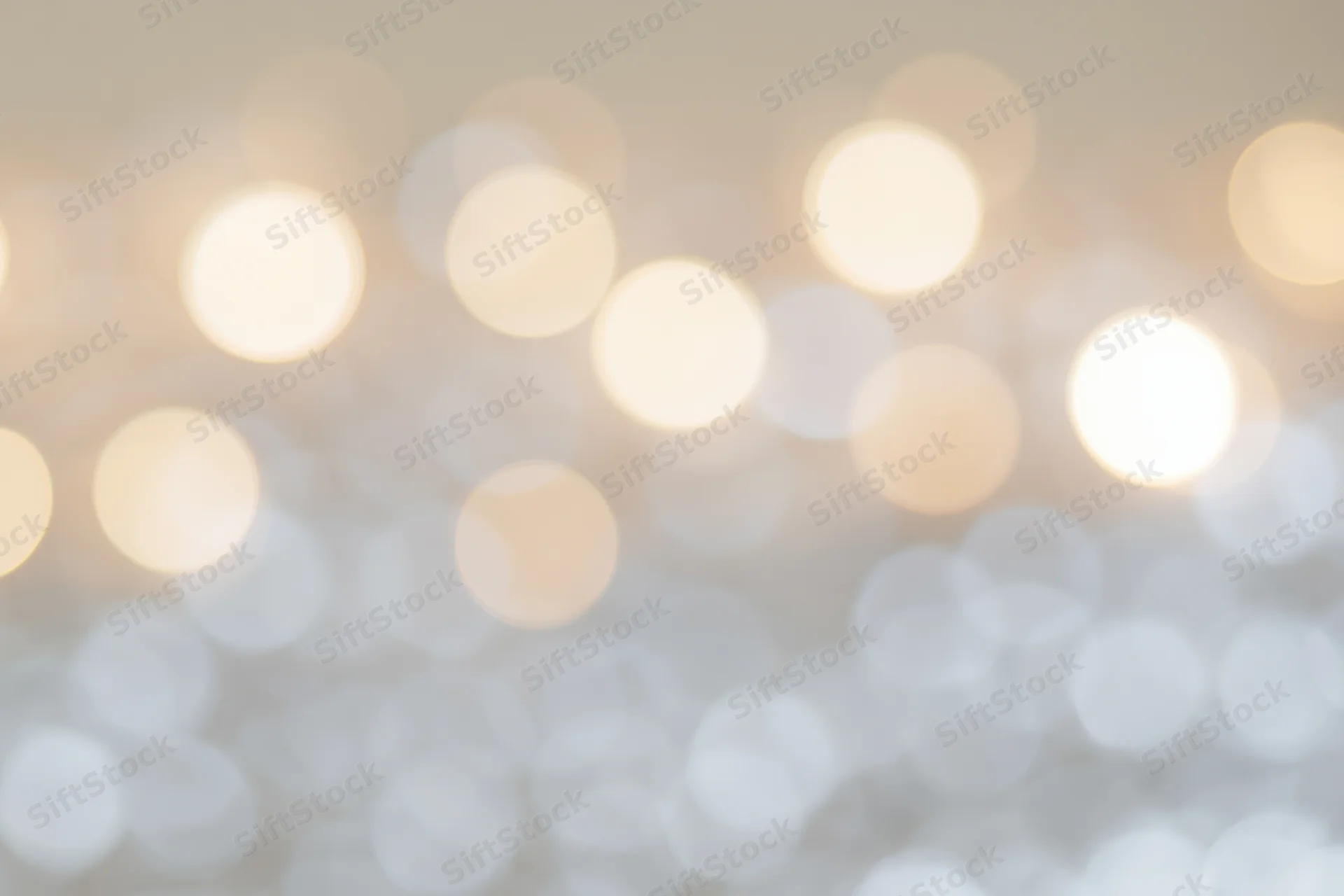 Soft out-of-focus bokeh background with scattered warm white lights