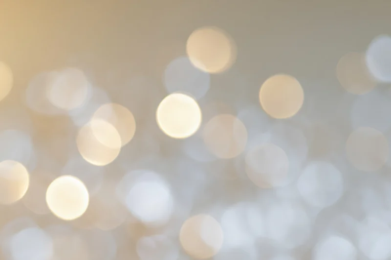 Soft out-of-focus bokeh background with scattered warm white lights