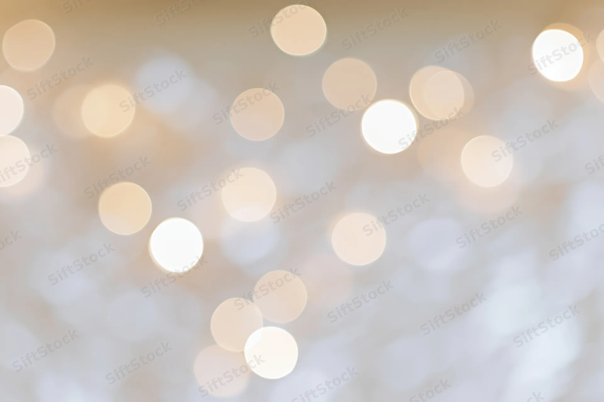 Soft out-of-focus bokeh background with scattered warm white lights
