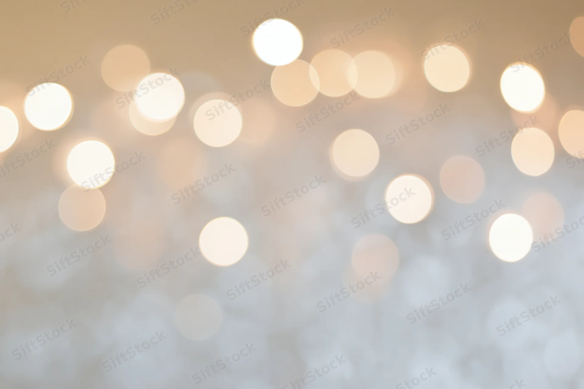 Soft out-of-focus bokeh background with scattered warm white lights