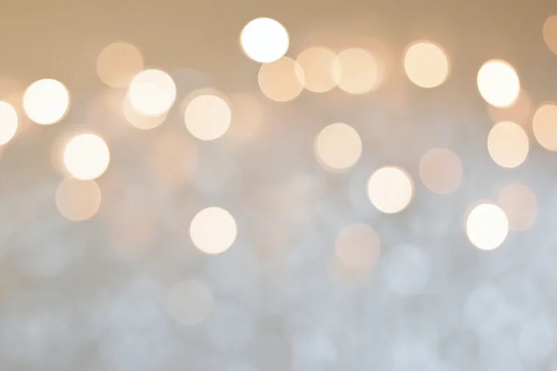 Soft out-of-focus bokeh background with scattered warm white lights