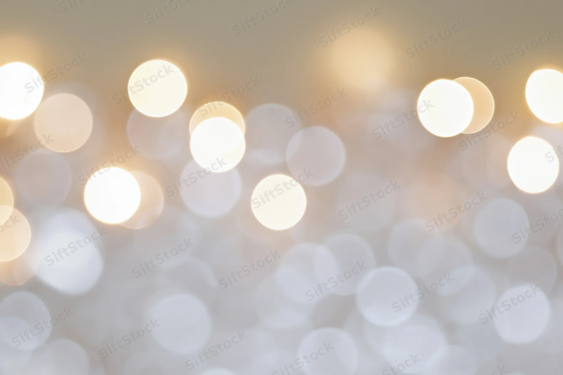 Soft out-of-focus bokeh lights in warm white tones scattered across a blurred background
