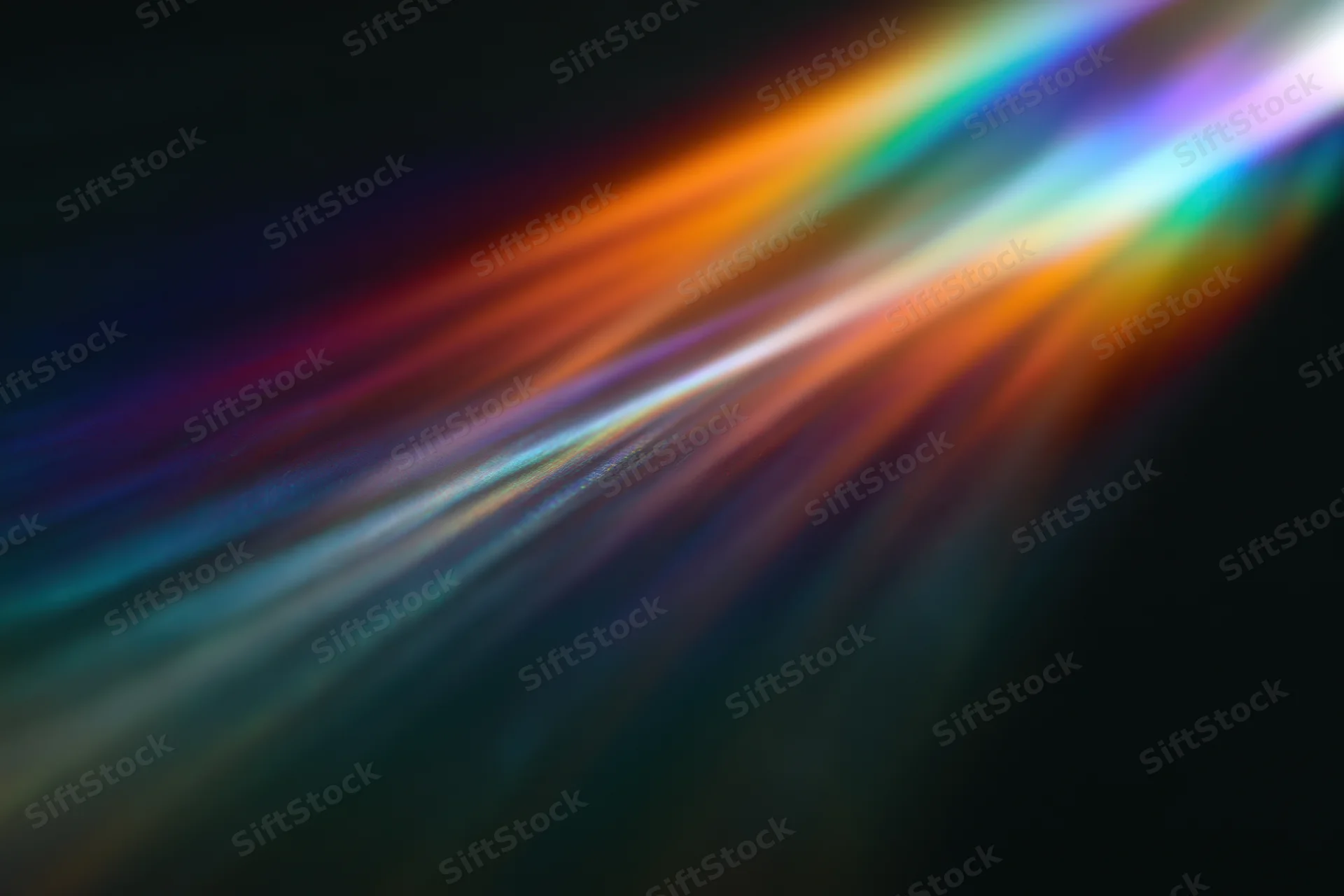 Prismatic light diffraction spreading across a dark surface
