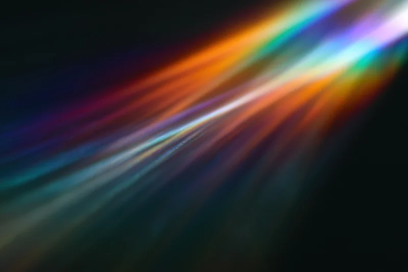 Prismatic light diffraction spreading across a dark surface