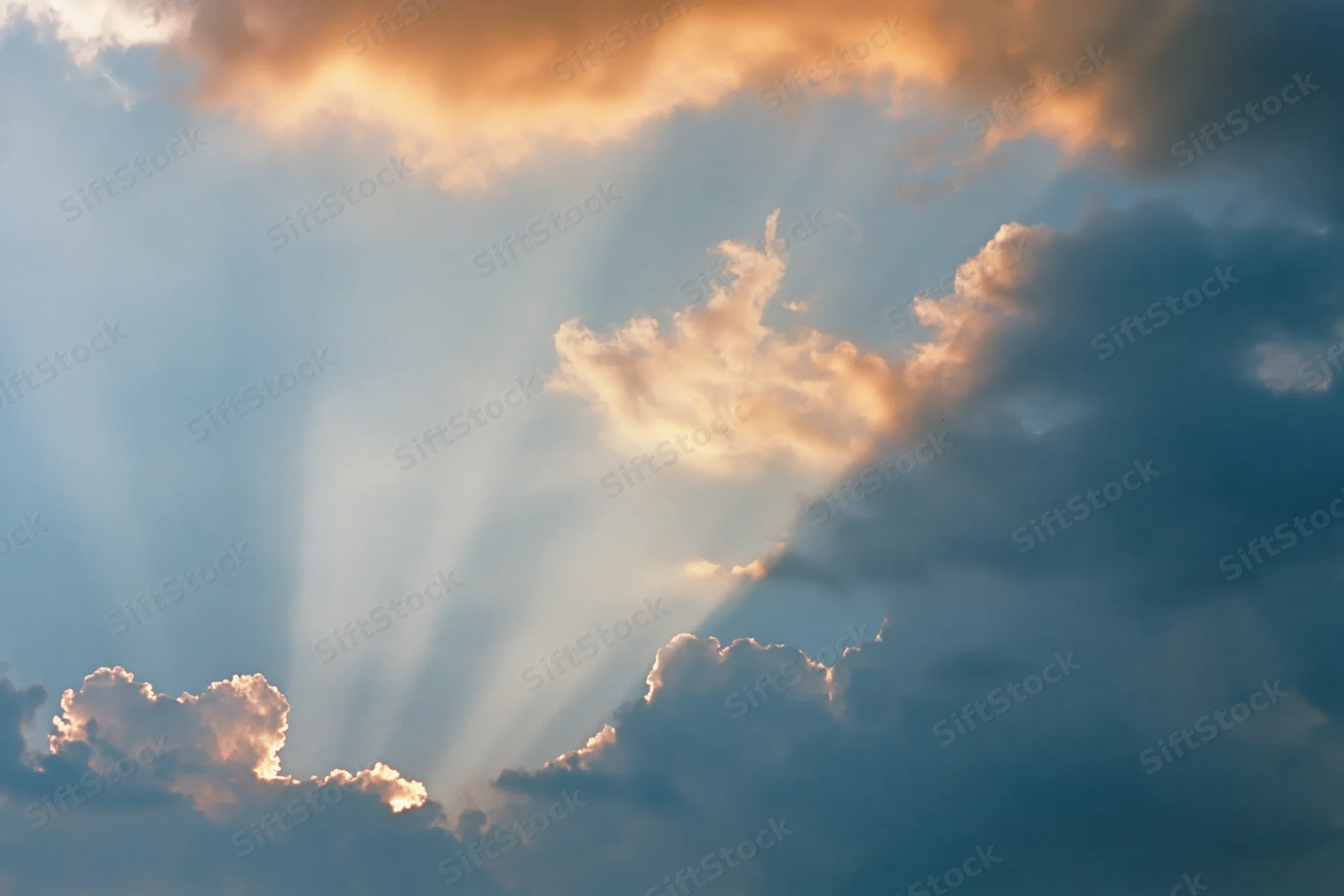 Sunlight breaking through dense clouds in the sky