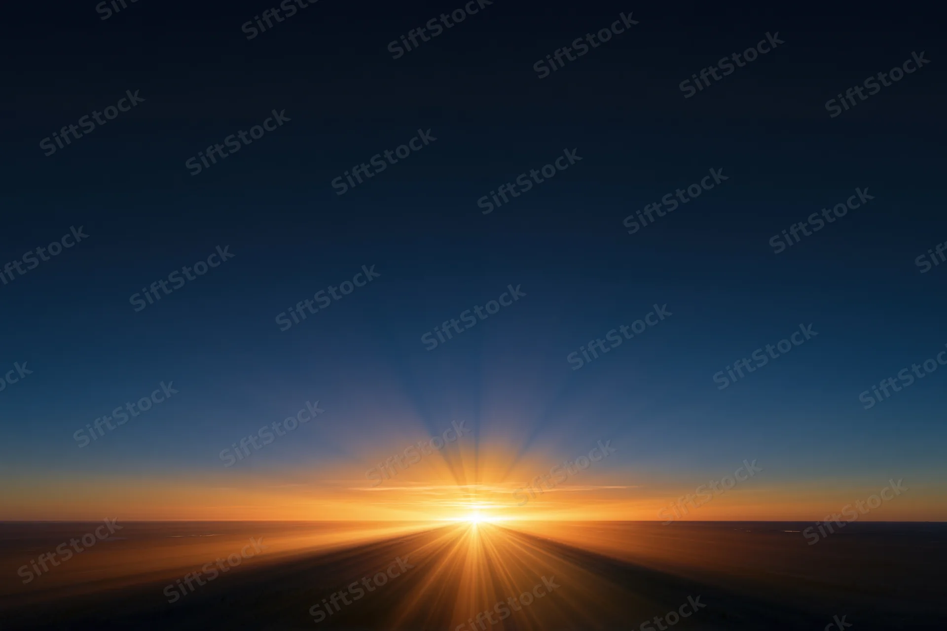 Golden sunrise radiating light rays across the horizon at dawn