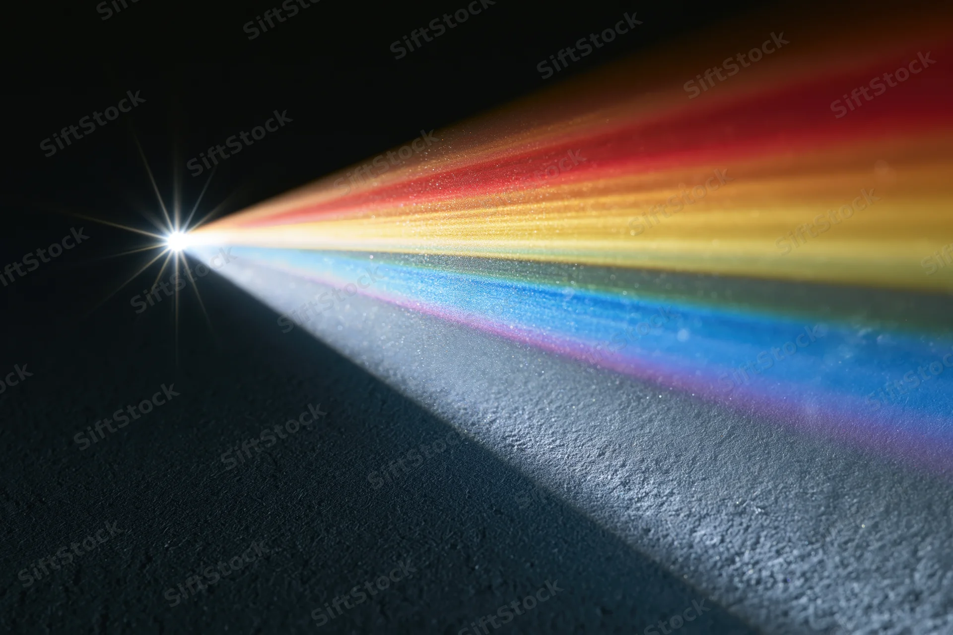 White light refracting through a glass prism casting a rainbow spectrum on a dark surface