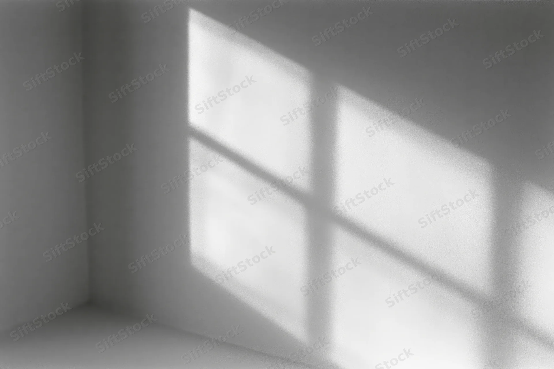 Diagonal shadow of window grid cast across white interior corner