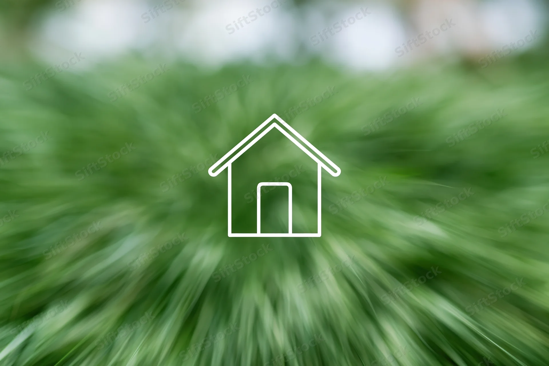 White outline house icon over blurred green foliage background