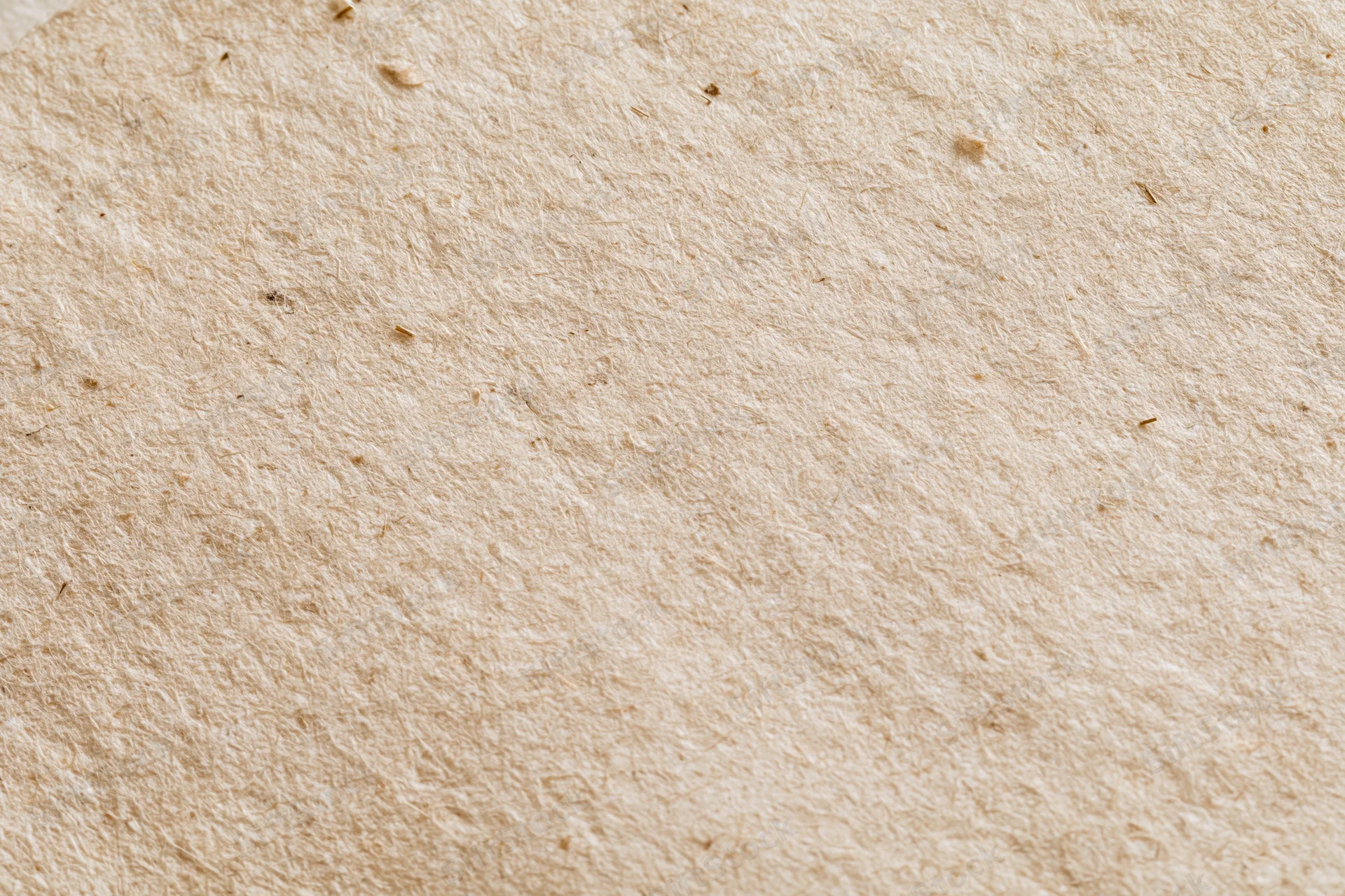 Close-up flat lay of a sheet of recycled kraft paper filling the frame