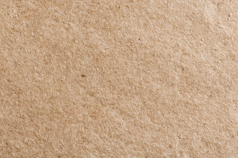 Close-up flat lay of plain kraft brown recycled paper surface
