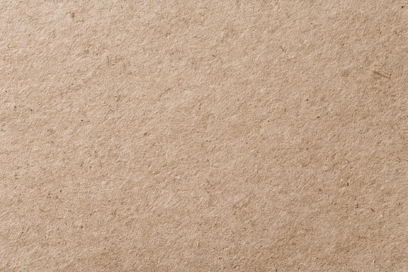 Close-up flat lay of plain kraft brown recycled paper surface
