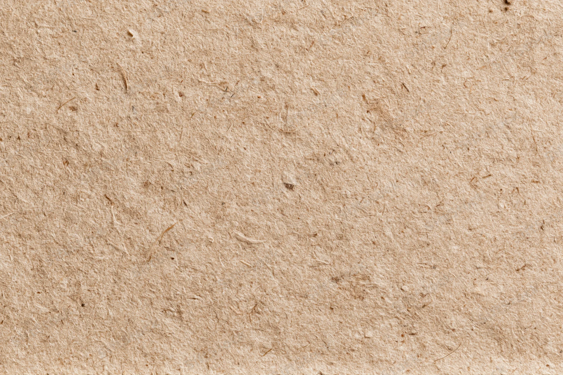 Close-up flat lay of recycled kraft cardboard surface filling the frame