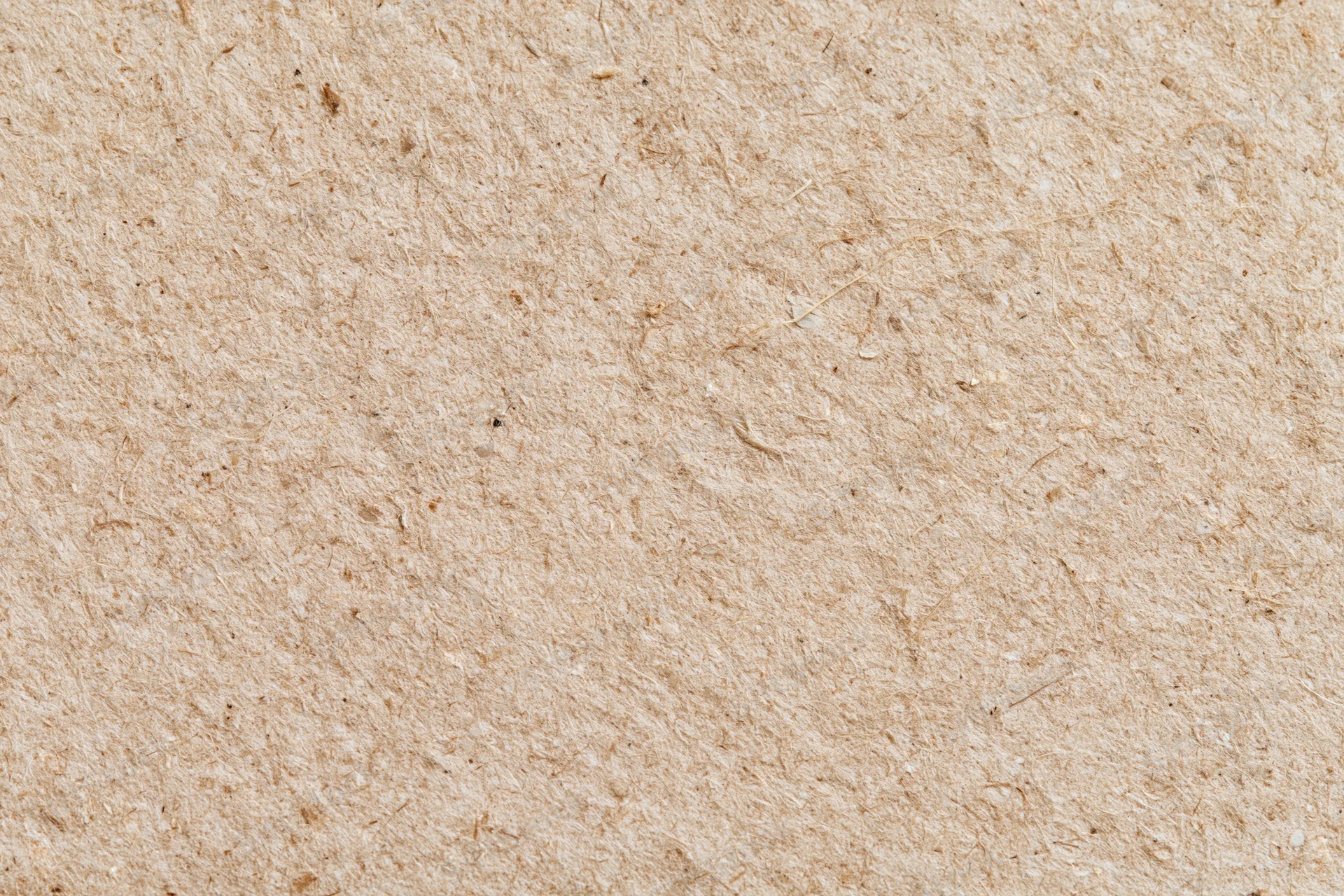 Close-up flat lay of recycled kraft cardboard surface filling the frame
