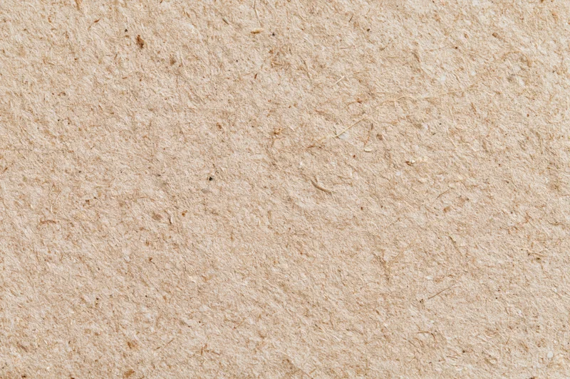 Close-up flat lay of recycled kraft cardboard surface filling the frame