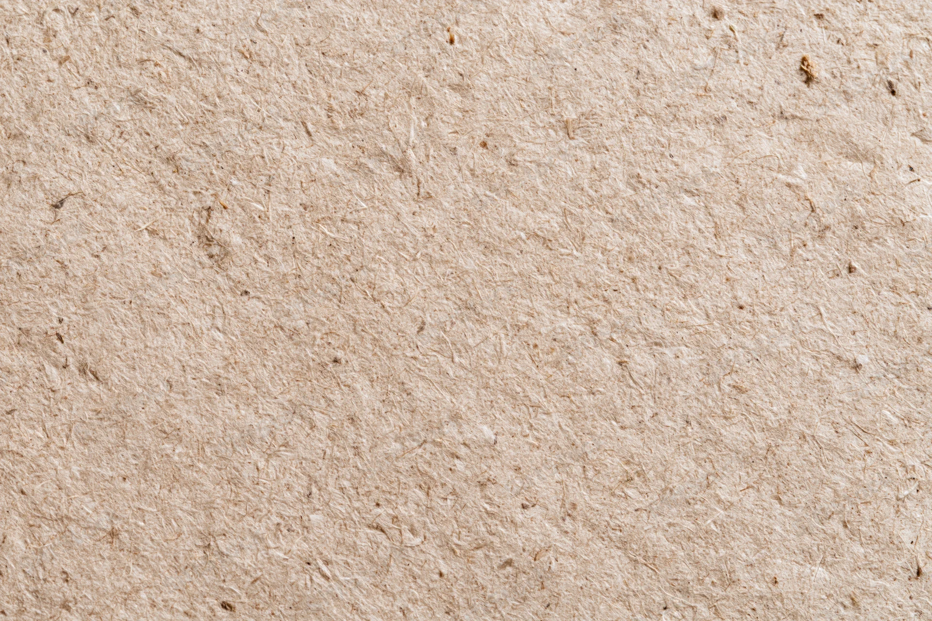 Close-up flat lay of recycled kraft cardboard surface filling the frame