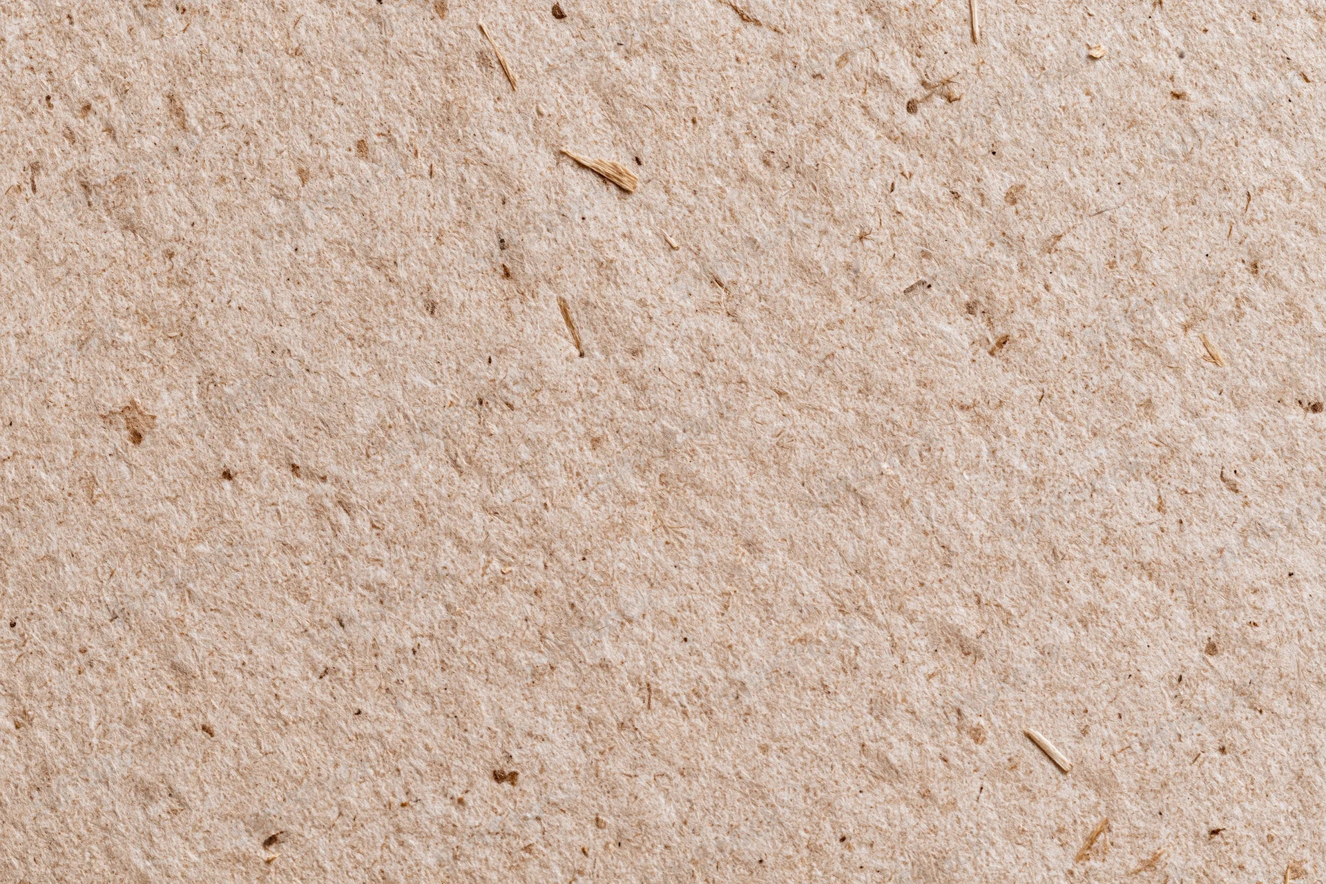 Close-up flat lay of recycled kraft cardboard surface filling the frame