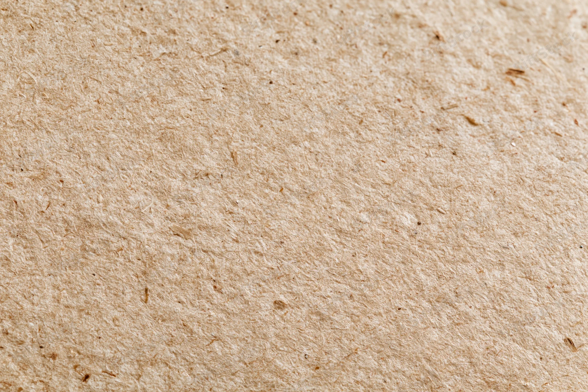 Close-up flat lay of recycled kraft cardboard surface filling the frame