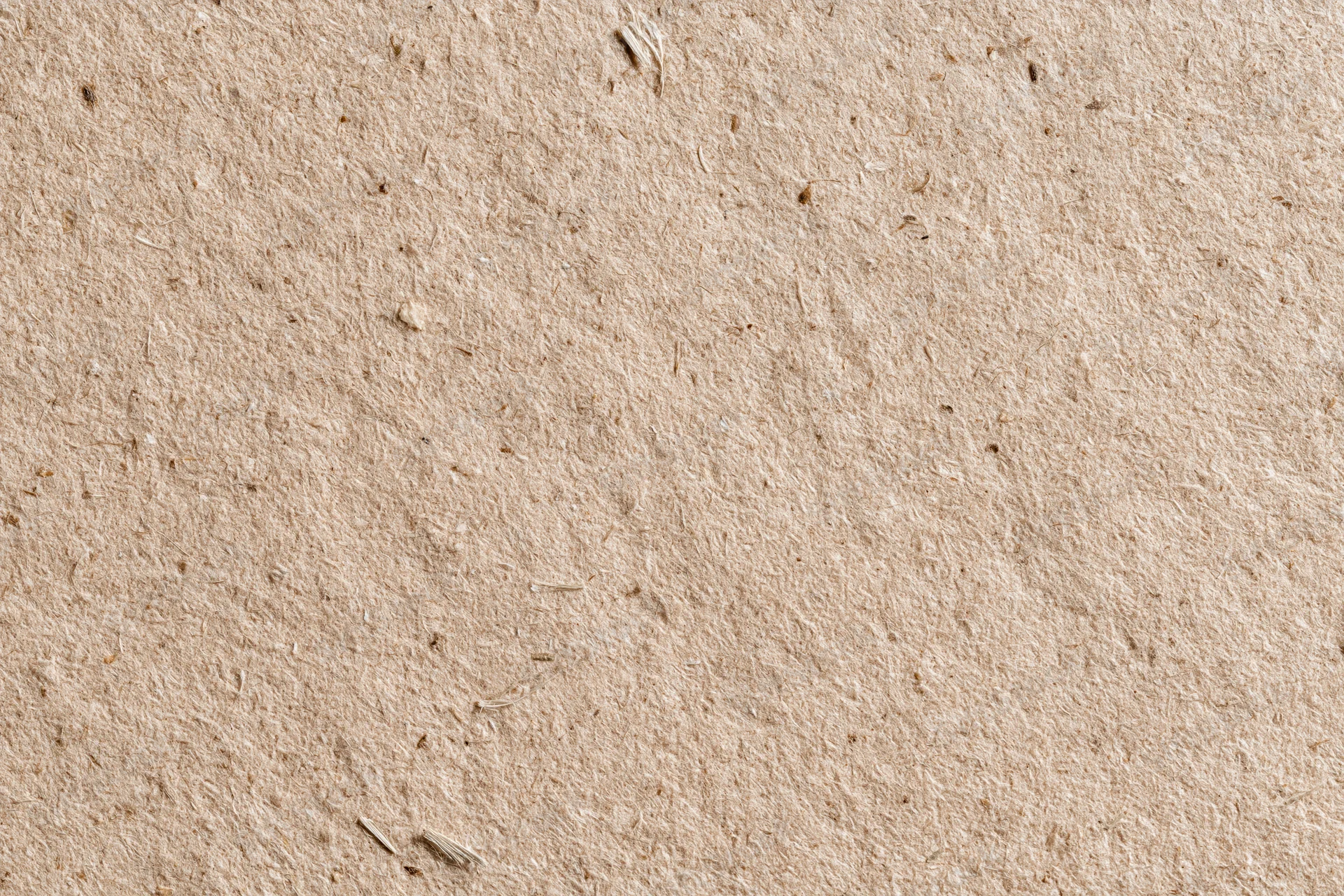 Close-up flat lay of recycled kraft cardboard surface filling the frame