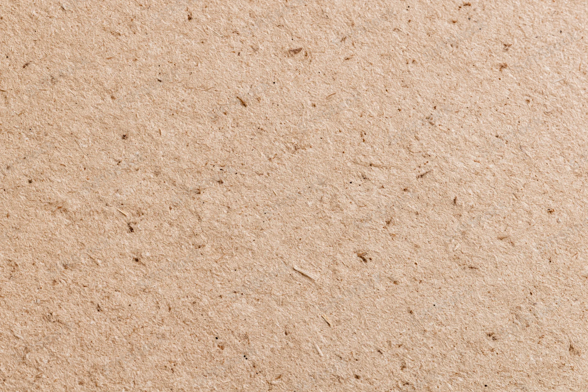 Close-up flat lay of recycled kraft cardboard surface filling the frame