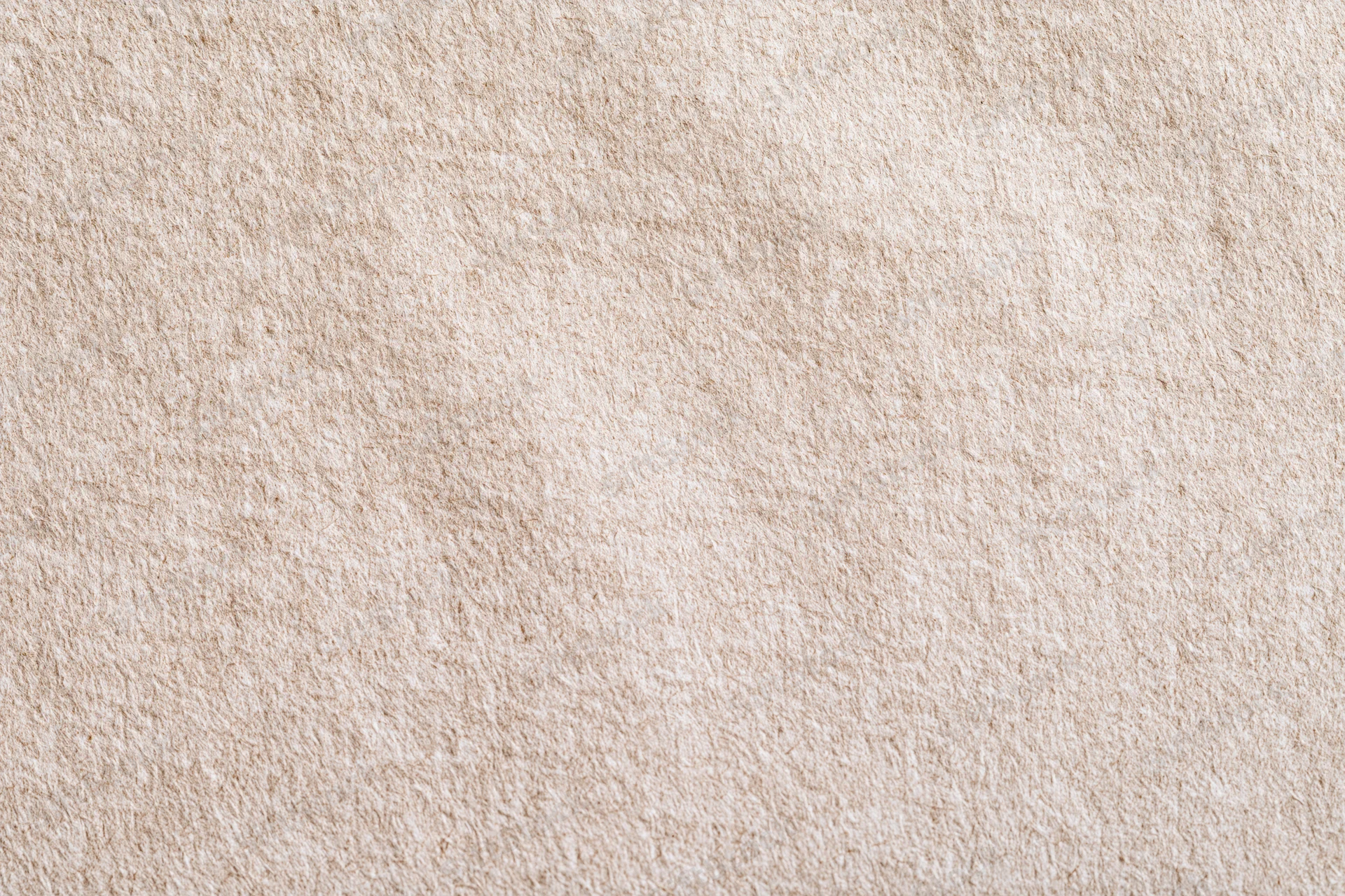 Close-up flat lay of beige recycled kraft paper with linen-like texture as background