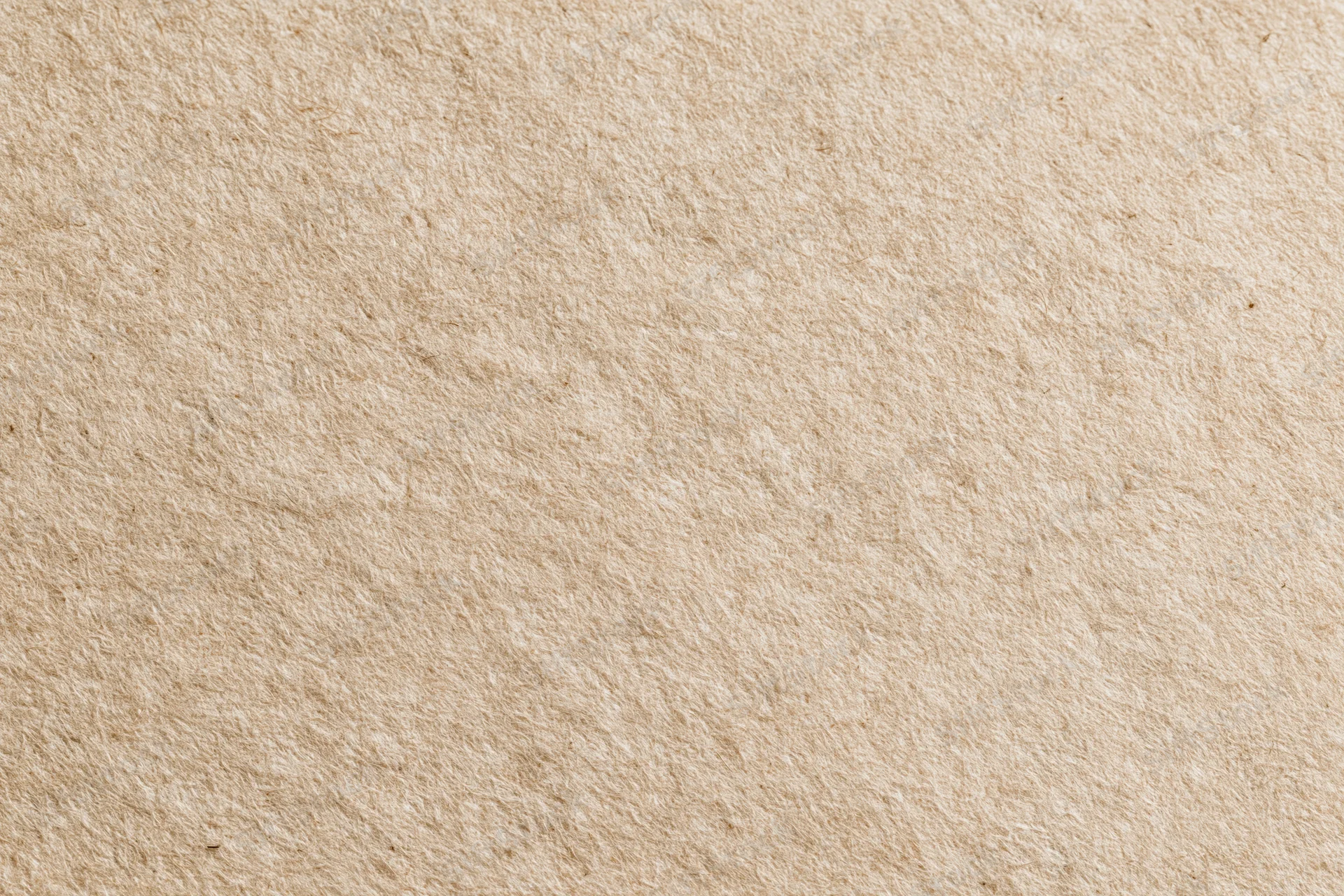 Close-up flat lay of recycled kraft paper with natural fiber texture and beige tone