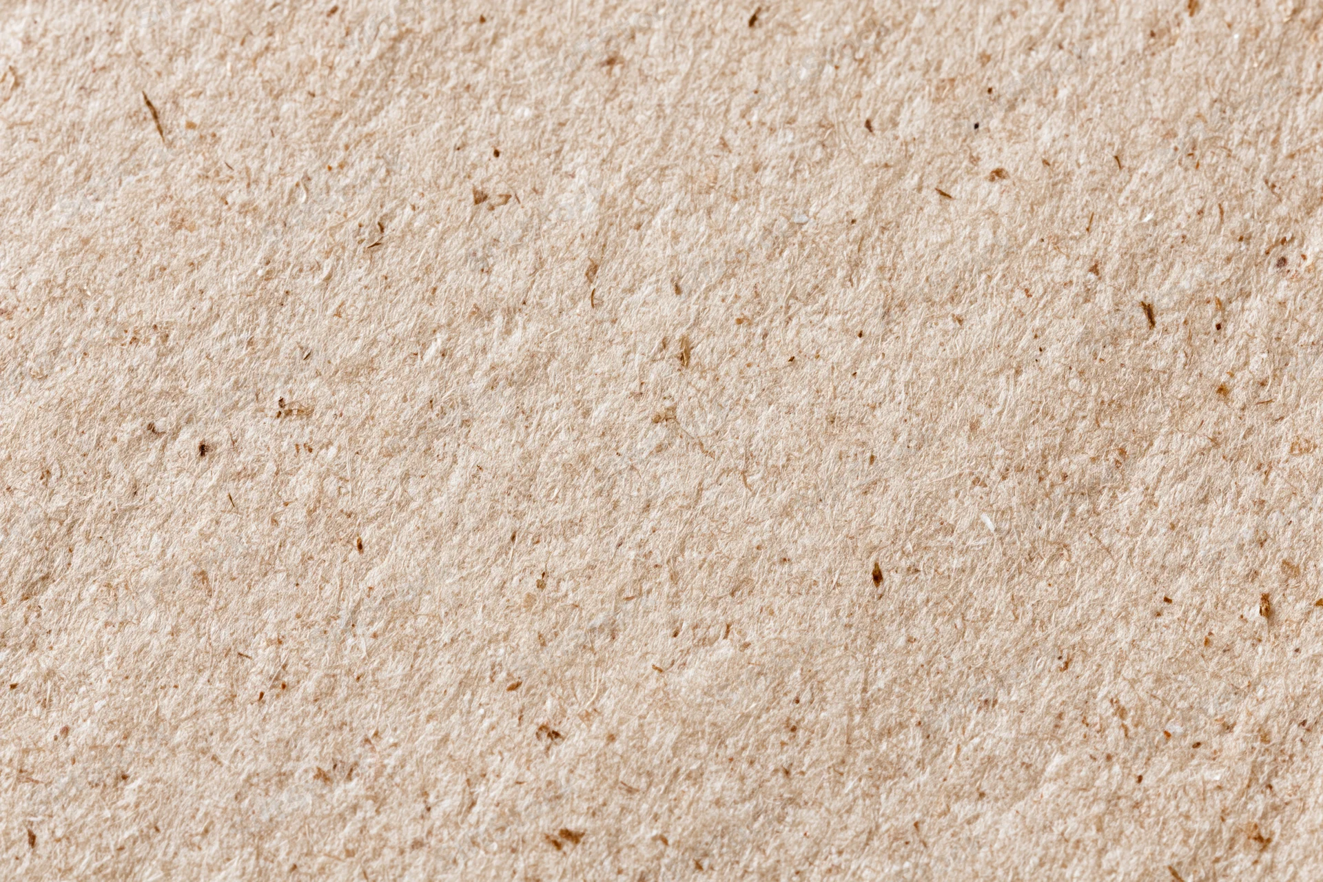 Close-up flat lay of recycled kraft paper surface filling the frame