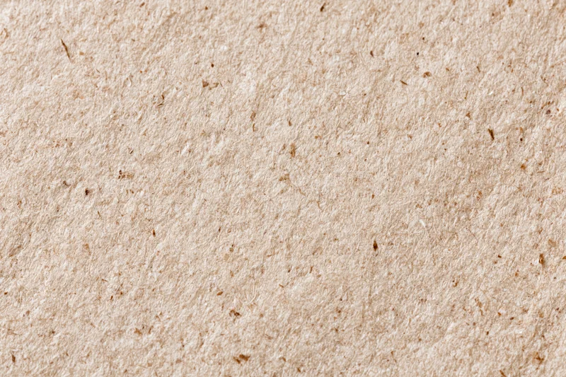 Close-up flat lay of recycled kraft paper surface filling the frame