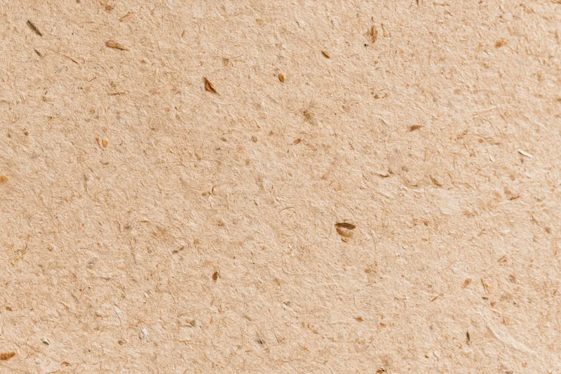 Close-up flat lay of recycled kraft paper surface filling the frame