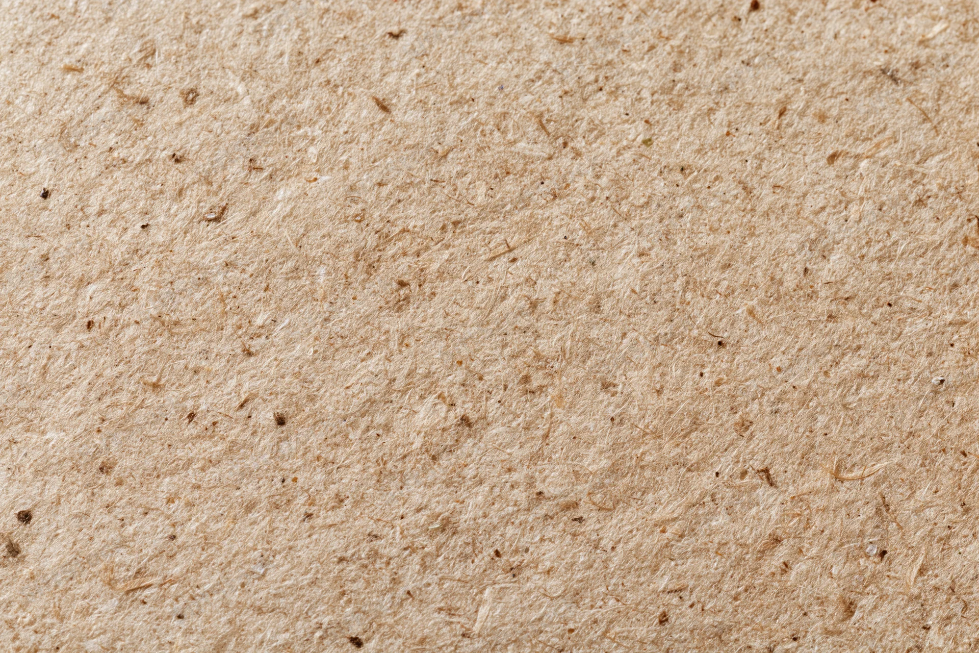 Close-up flat lay of recycled kraft paper surface filling the frame