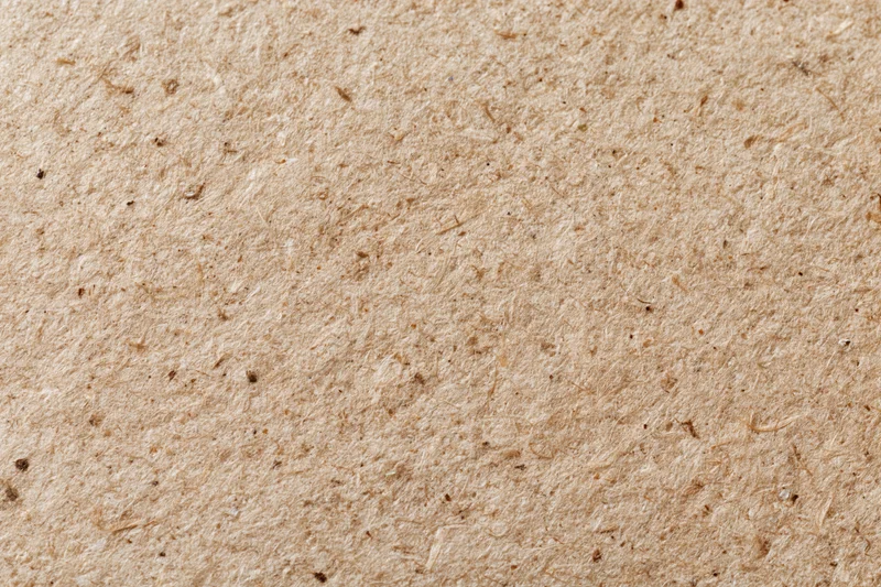 Close-up flat lay of recycled kraft paper surface filling the frame