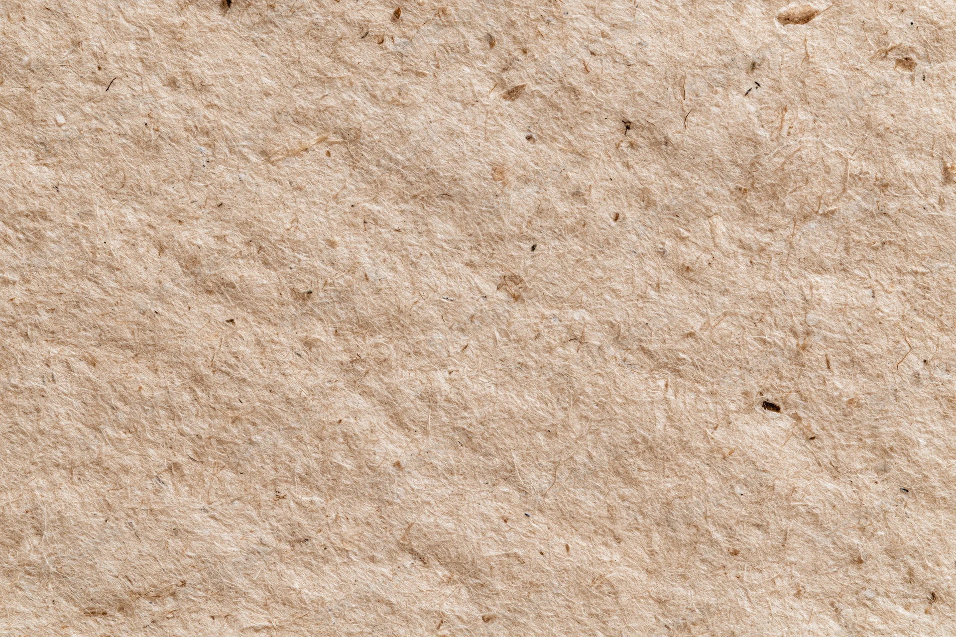 Close-up flat lay of recycled kraft paper surface filling the frame
