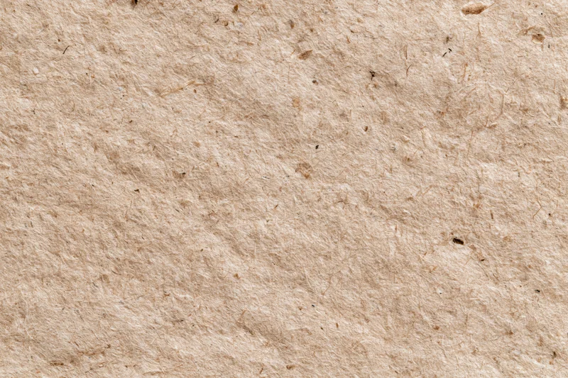 Close-up flat lay of recycled kraft paper surface filling the frame